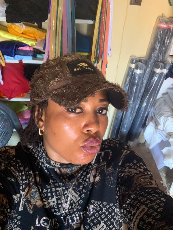 Selfie session showing streetwear-heavy look in Nigerian workshop space