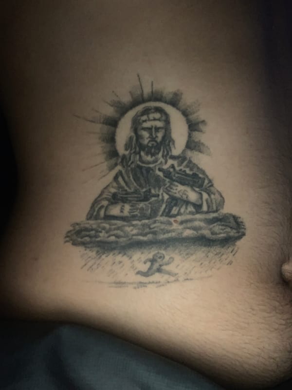 Religious tattoo featuring Christ figure documented in Buenos Aires