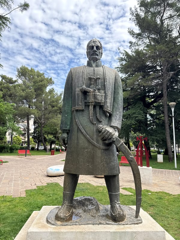 Morning park scenes documented in Podgorica featuring bronze statue