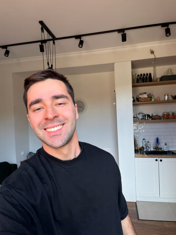 Two people share digital devices in Tbilisi indoor setting