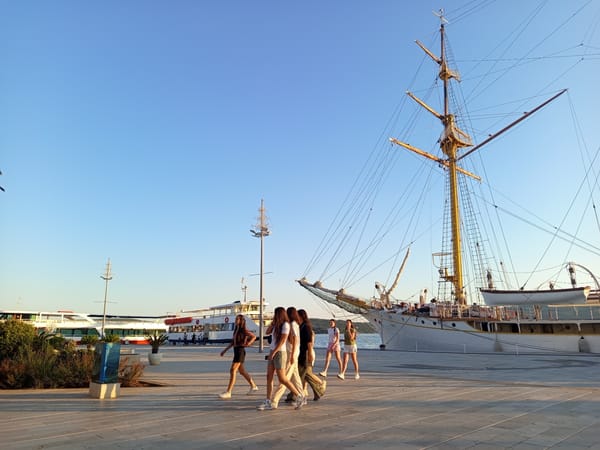Tall ship docked at Tivat's waterfront on a summer afternoon