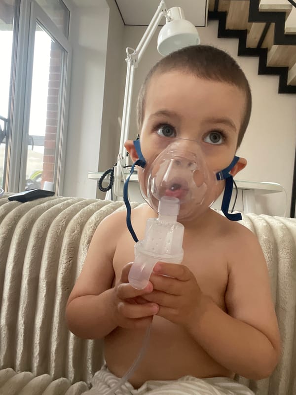 Nebulizer treatment at home in Izhevsk, with a cat nearby.