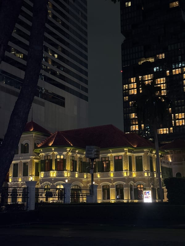 Nighttime Bangkok: colonial facades meet Sathorn skyscrapers