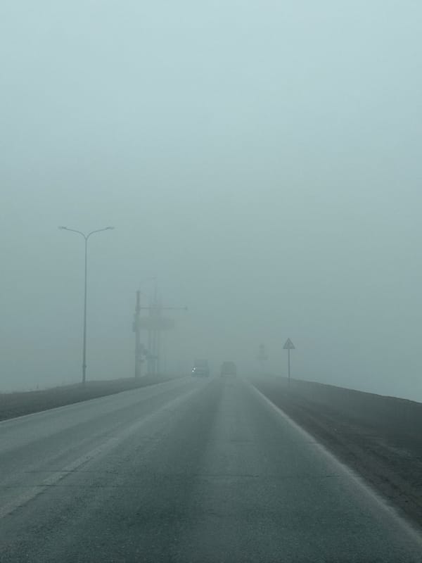 Dense fog blankets wet roadway in Chaikovsky, Russia