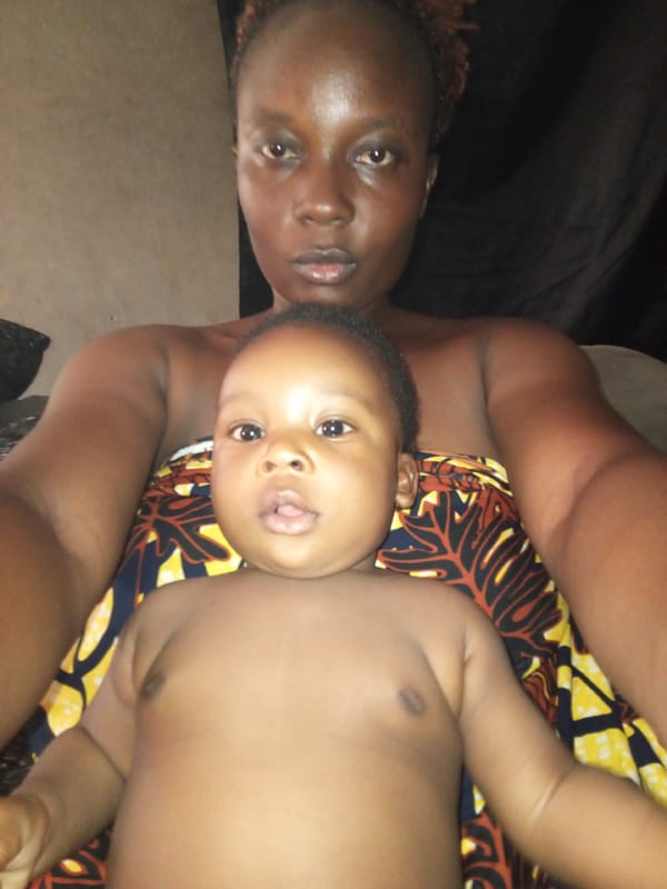 Adult and baby photographed together in Sabon Tasha, Nigeria