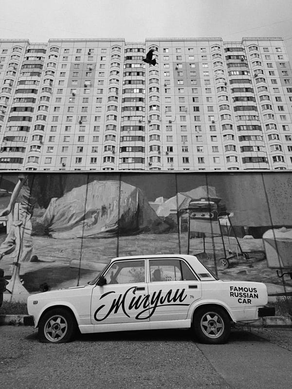 Odintsovo apartment blocks and street-parked Lada, June morning