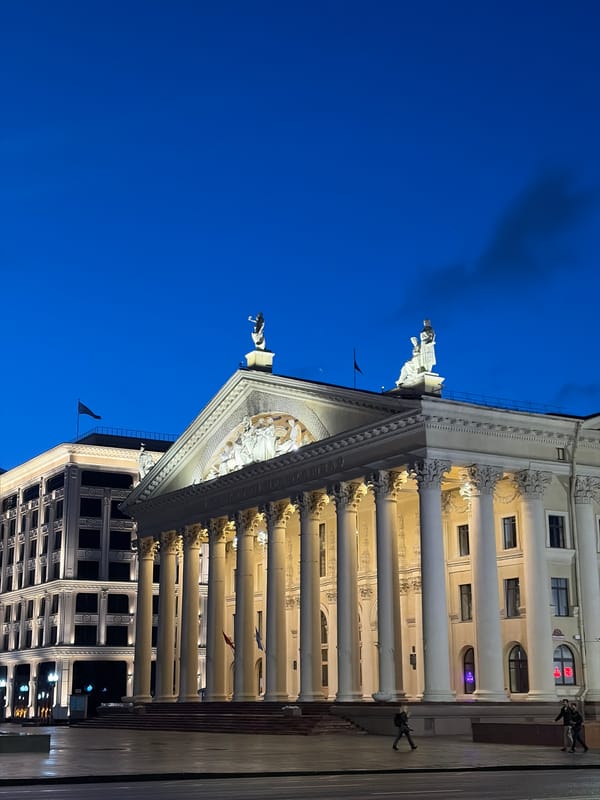 Minsk city center at dusk, landmarks glowing.