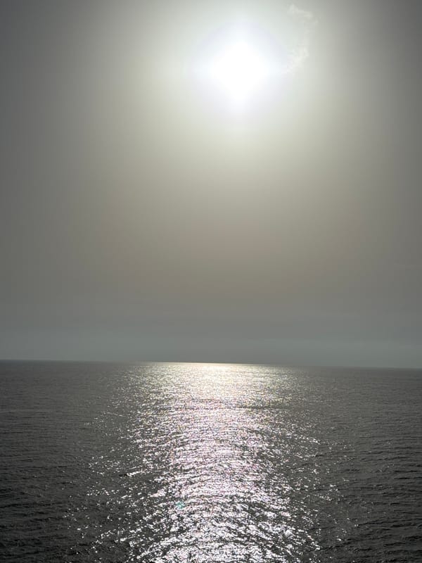 Cargo ship underway on calm open ocean