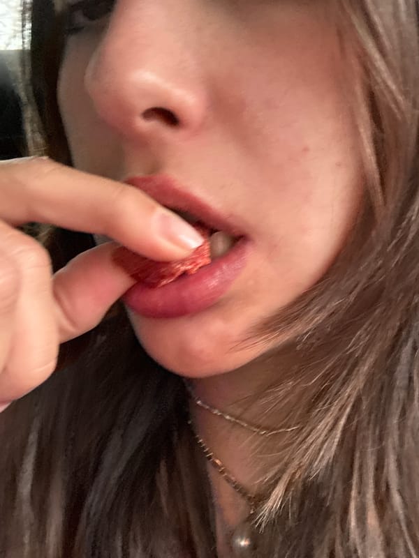 Person holds dried fruit near face in Mexico City