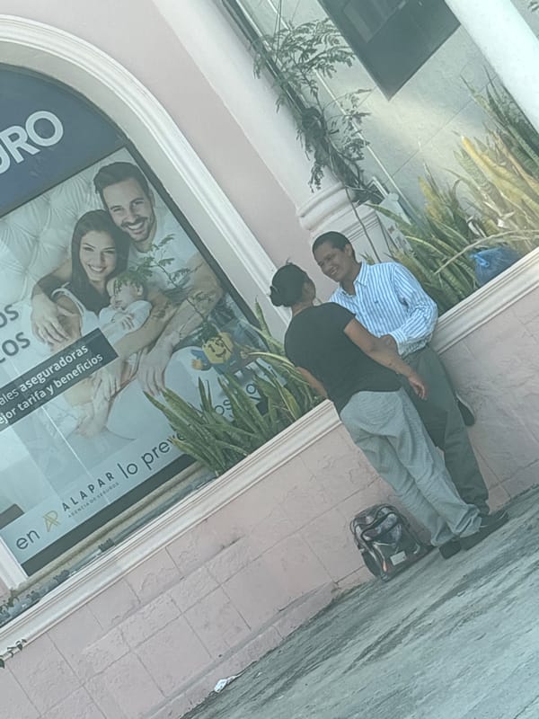 Two men stand outside storefront in Tampico, Mexico