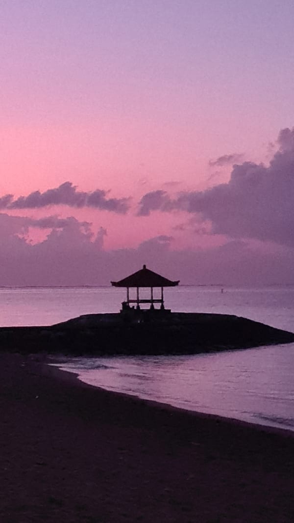 Sanur Beach at golden hour, lights and silhouettes