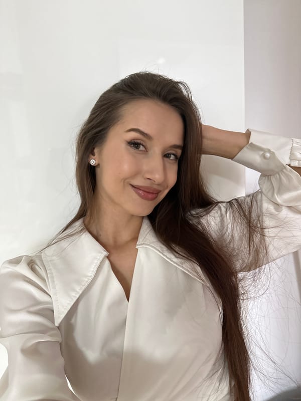 Woman takes mirror selfies in white blouse in Yekaterinburg