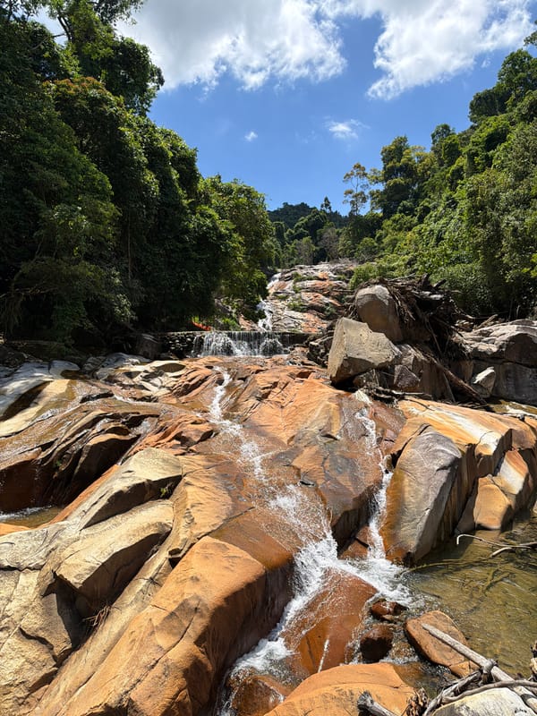 Rocky waterfall tumbles through lush forest outside Huế