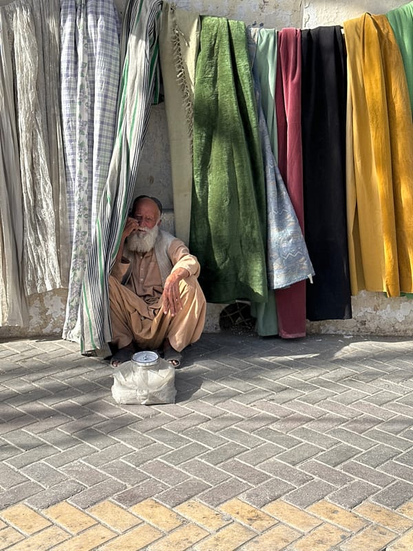 Midday street life along a busy Quetta sidewalk