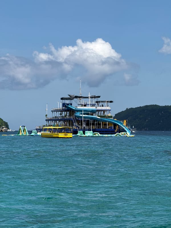 Recreational boat spotted near Nusa Penida lighthouse at dawn