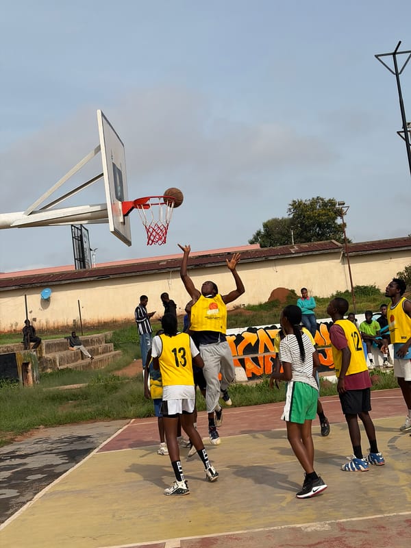 Pickup basketball on a worn outdoor court in Jos, Nigeria