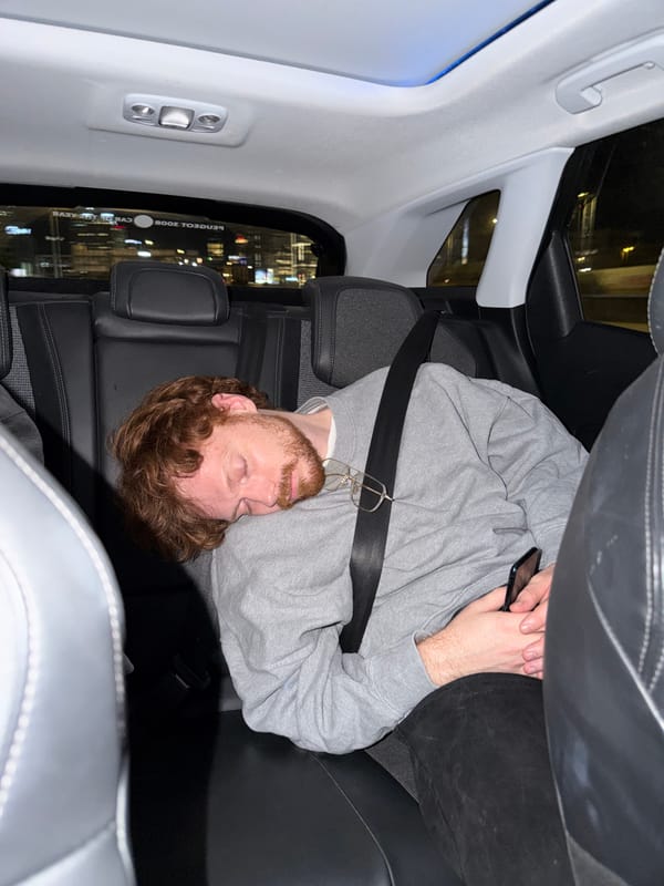 Man rests in back seat of car in Tel Aviv