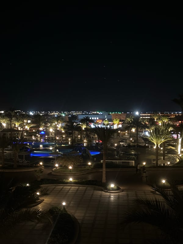 Nighttime resort area captured in Egypt with palm trees