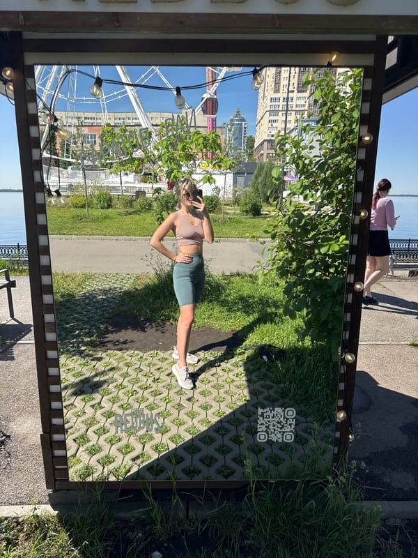 Woman takes morning selfies at mirrored Saratov embankment installation