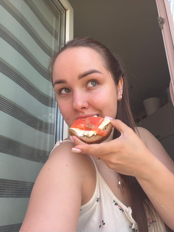 Woman enjoys salmon sandwich in Chaikovsky, Russia
