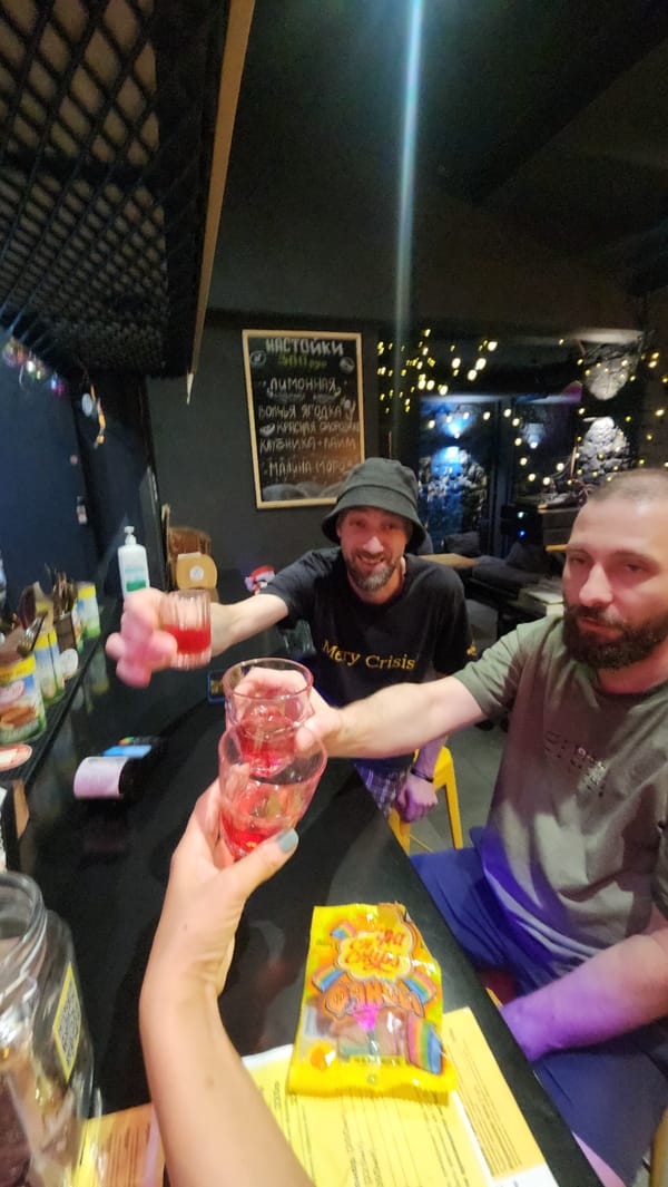 Red shots raised in a dim Moscow bar