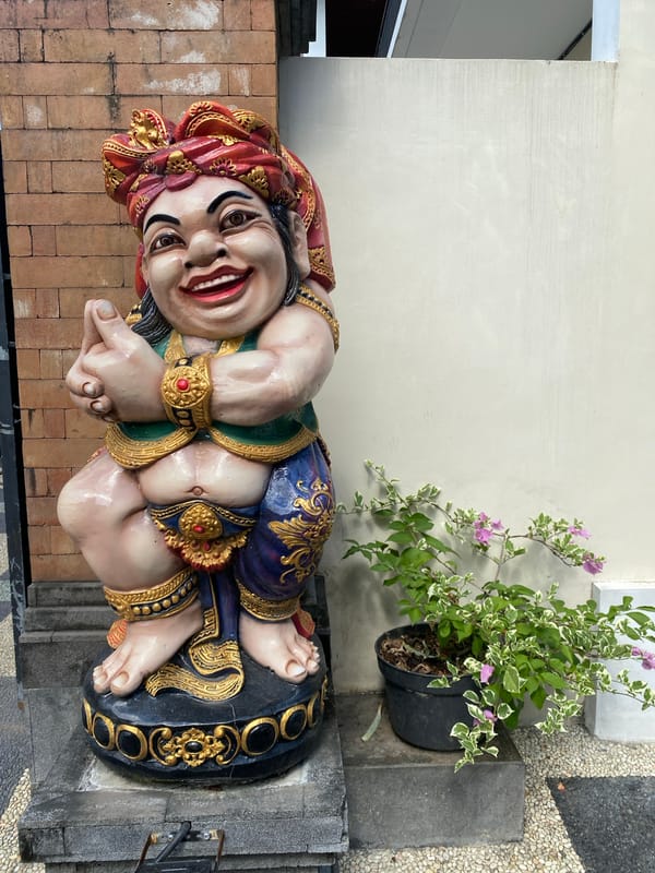 Indoor scenes with decorative statue and desk setup documented