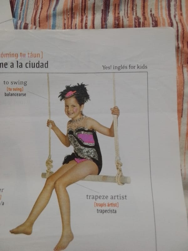 Bilingual English-Spanish learning materials photographed in La Tagua