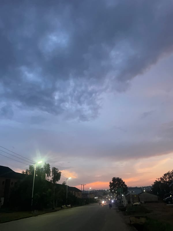 Evening street life and sunset skies in Jos, Nigeria