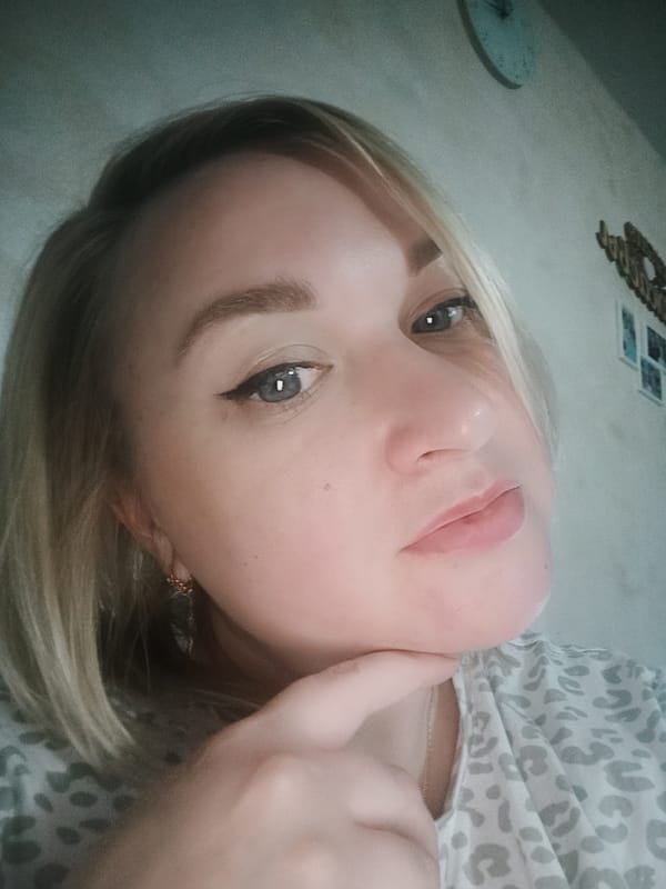 Blonde woman poses for multiple selfie shots indoors