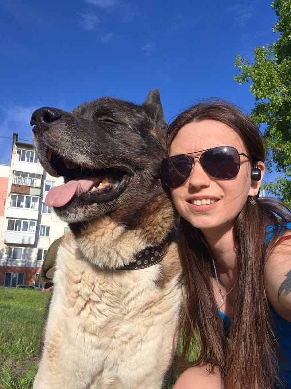 Woman and dog enjoy sunny afternoon in Russian neighborhood