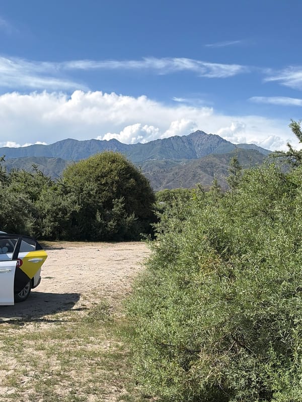 Beach day with a parked car and a wood-burning stove nearby
