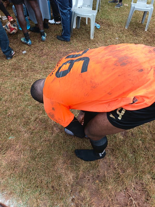 Soccer match draws spectators to grassy field in Nairobi