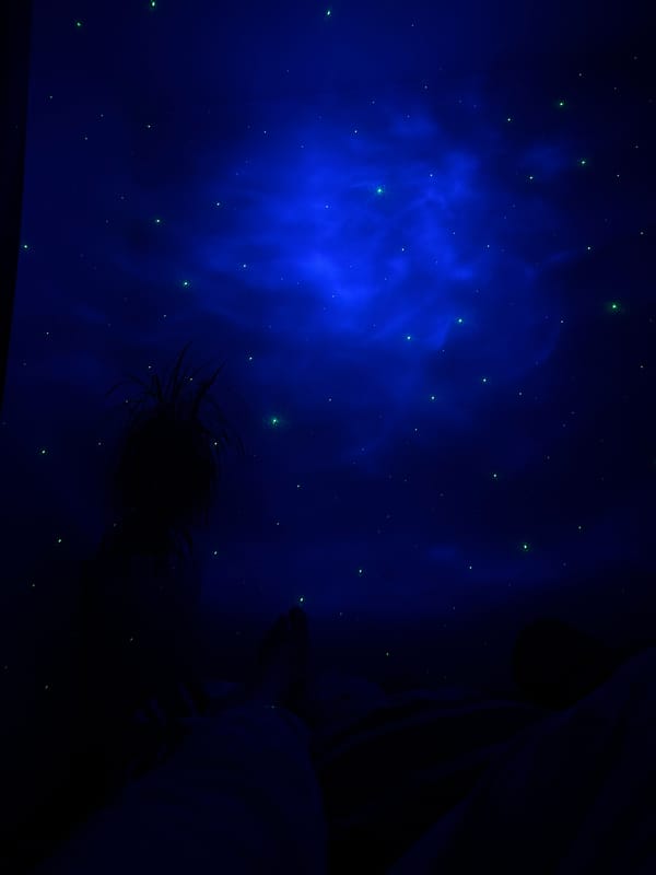 Galaxy projector night in a Perm apartment, city views outside
