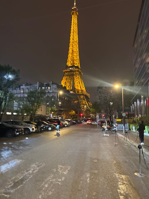 Rainy night view of illuminated Eiffel Tower in Paris