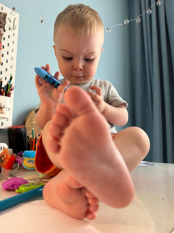 Toddler enjoys creative playtime with toys and drawing in Votkinsk