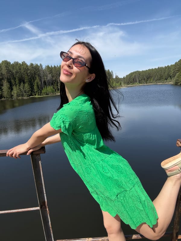 Woman poses at scenic lake overlook in Votkinsk, Russia