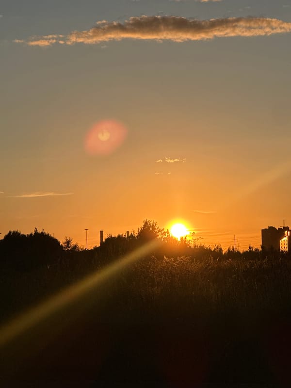 Sunset at Lake Ladoga, sneakers on asphalt nearby