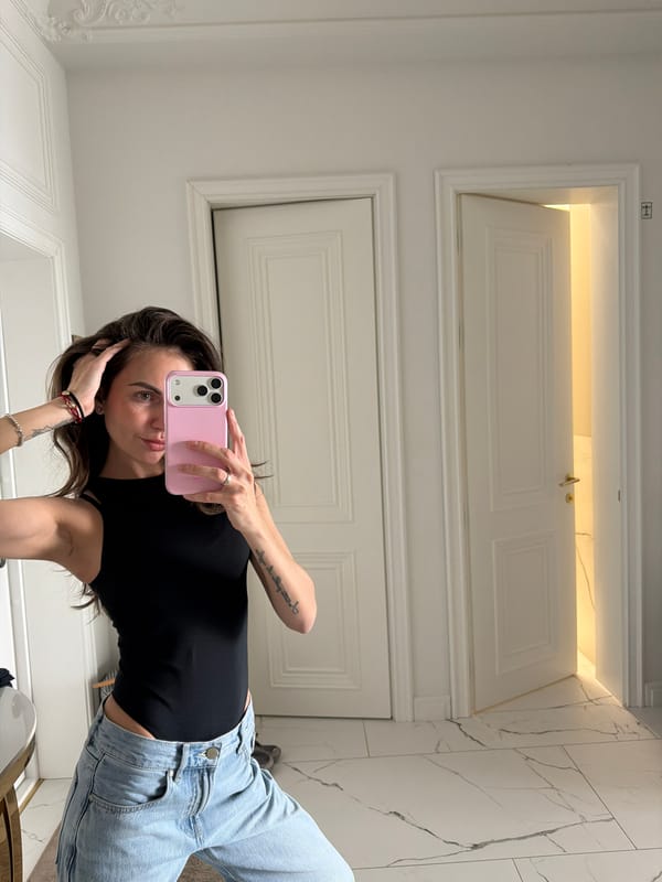 Woman takes mirror selfie with pink phone in Krasnoyarsk