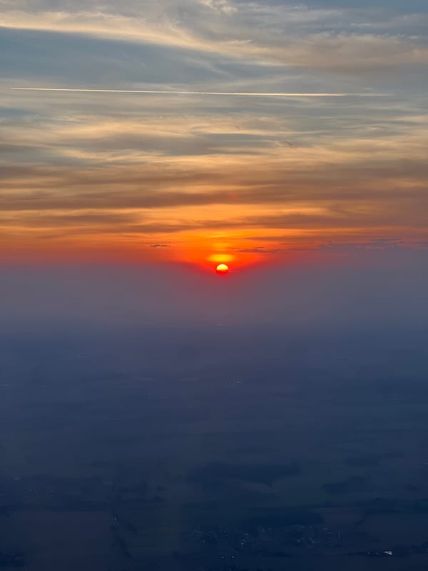 Vivid red sunset observed through orange clouds in Spirago, Italy