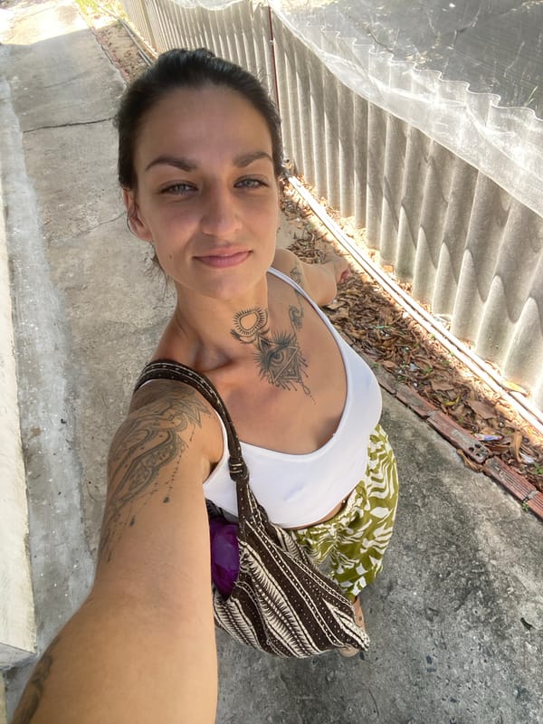 Woman takes selfies outside house in Mũi Né, Vietnam