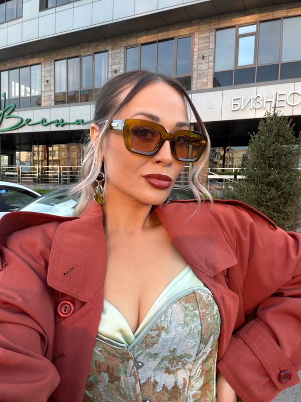 Woman poses for photo outside business building in Krasnoyarsk