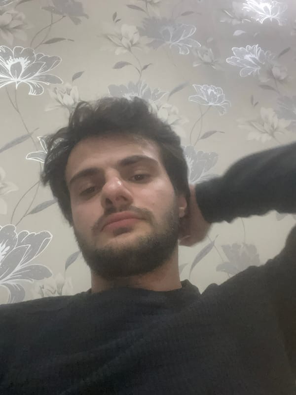 Man photographed multiple times in Tbilisi indoor setting