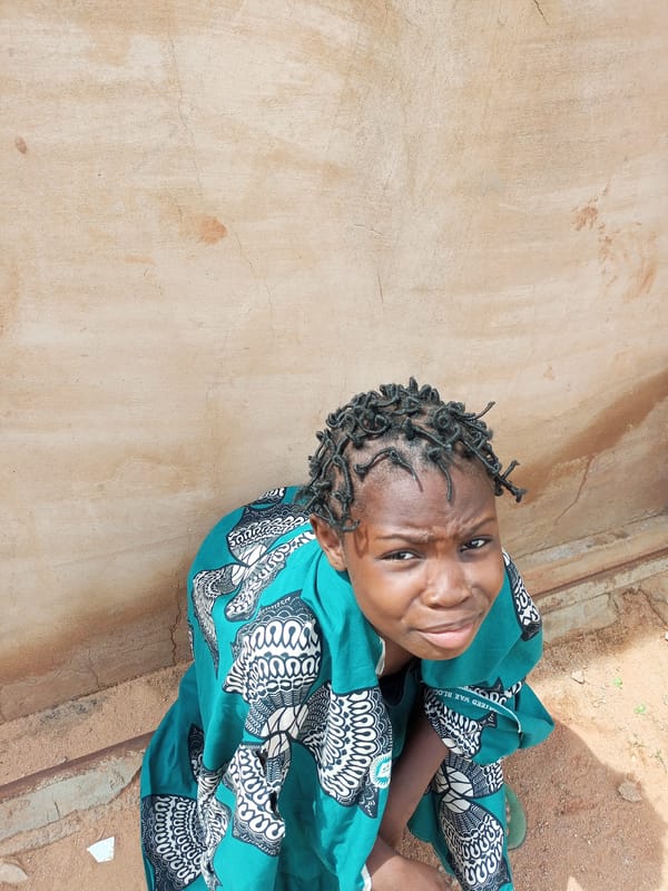 Everyday life in Tempure, Nigeria, around a dusty compound