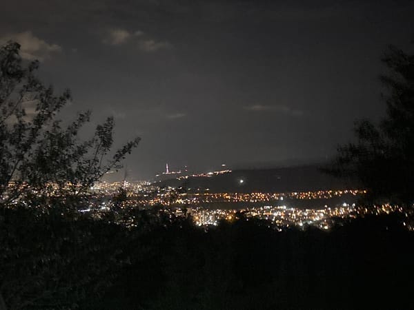 Evening gathering at Tbilisi cemetery overlooks illuminated city