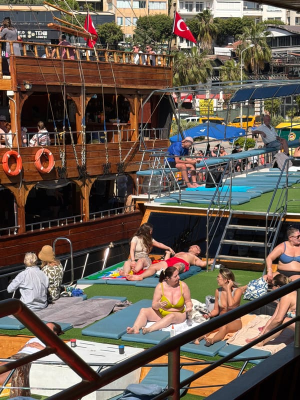 Tourist documents morning boat tour of Alanya coastline landmarks