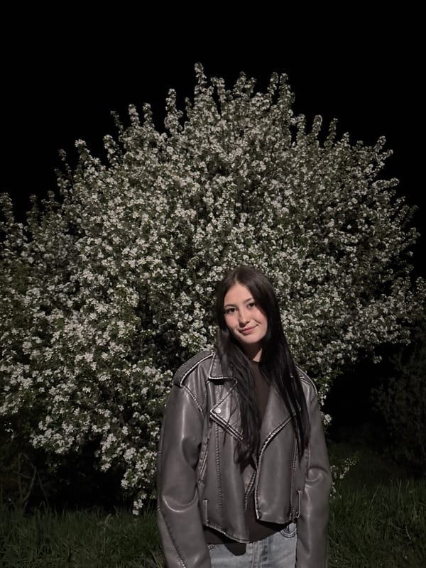 Woman observed near blossoming tree in Фоки park at night