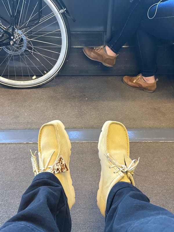 Two pedestrians meet near bicycle on London street