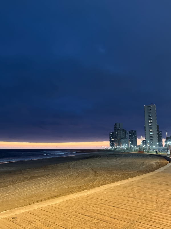 Iquique waterfront at dusk, boardwalk lights coming on