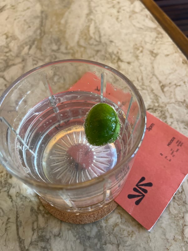 Citrus drink photographed on cork coaster in North Kuta