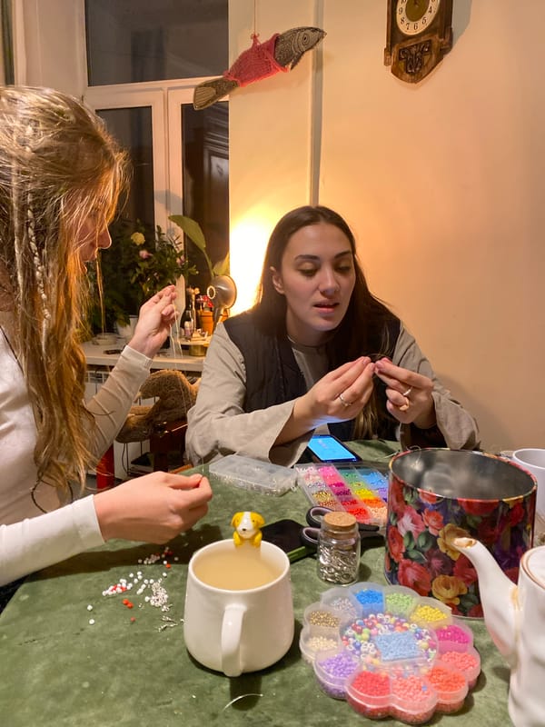 Two women craft beaded jewelry in Moscow